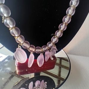 Pink long necklace with shell trinkets